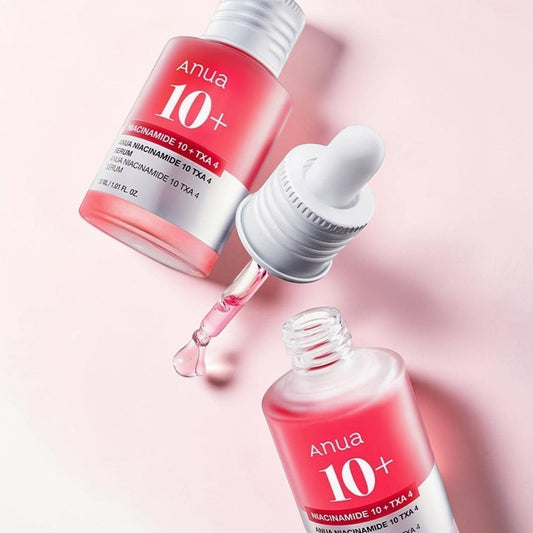 Anua Niacinamide 10% + TXA 4% Serum in a pink glass bottle with a dropper. Lightweight serum for brightening and even skin tone.