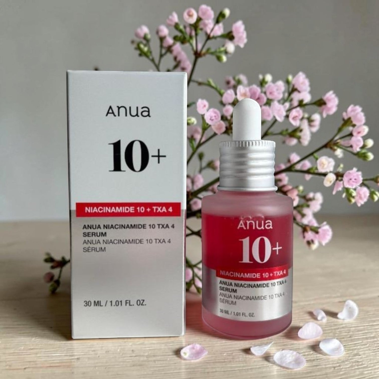 Anua Niacinamide 10% + TXA 4% Serum bottle and box, pink serum, clear dropper, white box with red accents, 30ml size.